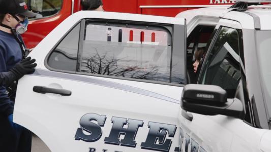 Police and firemen tend to a woman suspected of having COVID-19 in Washington State.