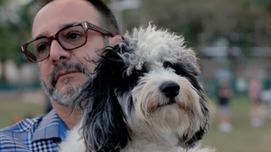 Felipe Laverde and his dog outside his Miami apartment.